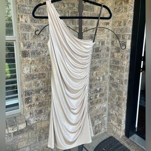One shoulder champagne colored dress with beading down the side.